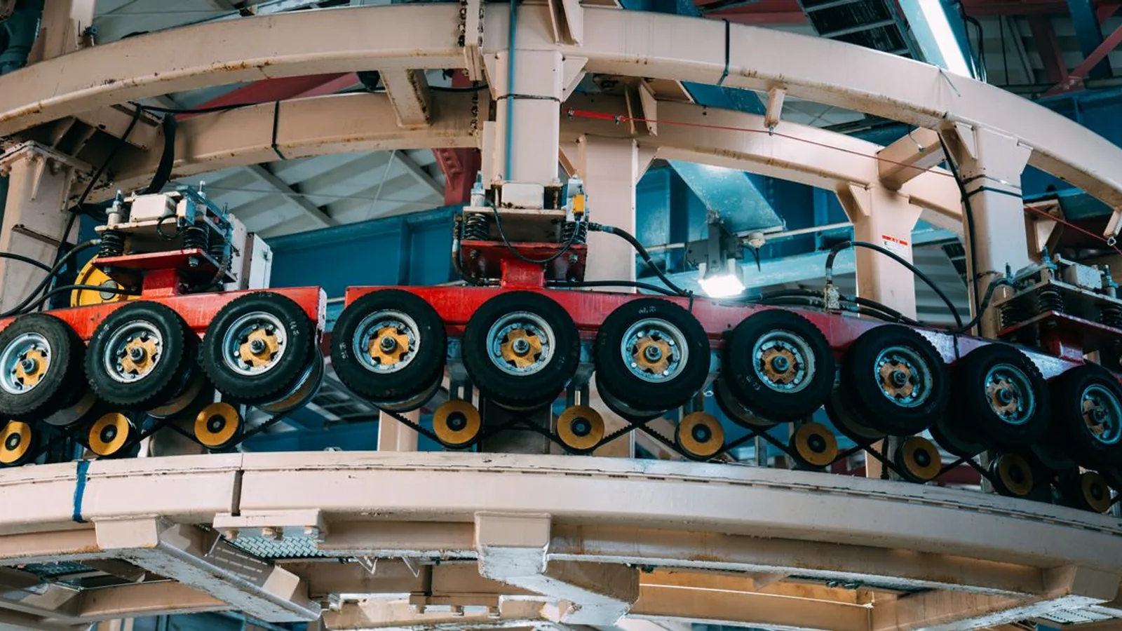 Close-up view of a complex industrial conveyor system inside a manufacturing facility.