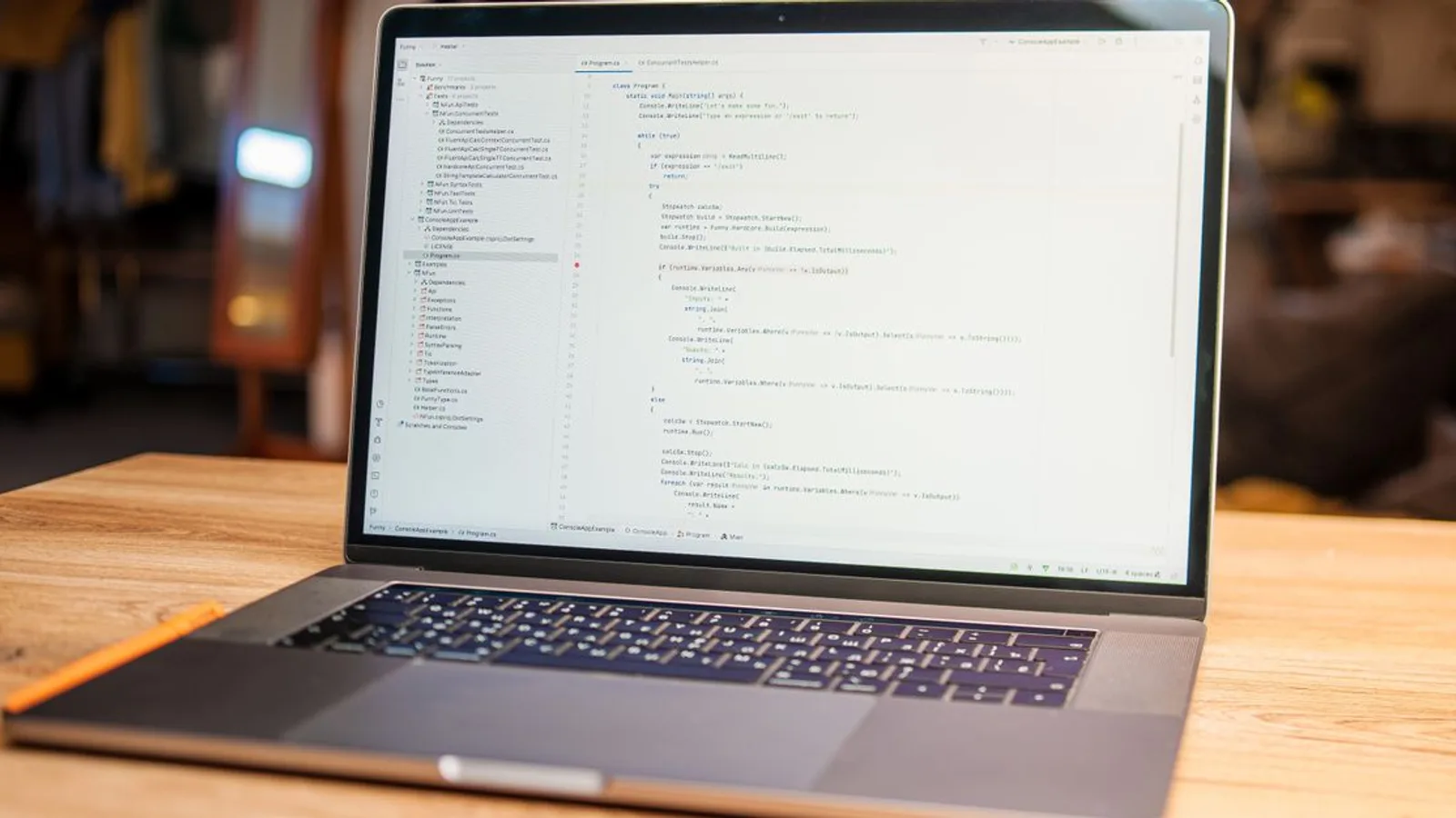 Open laptop with visible code on screen on a wooden desk in a modern, cozy workspace.