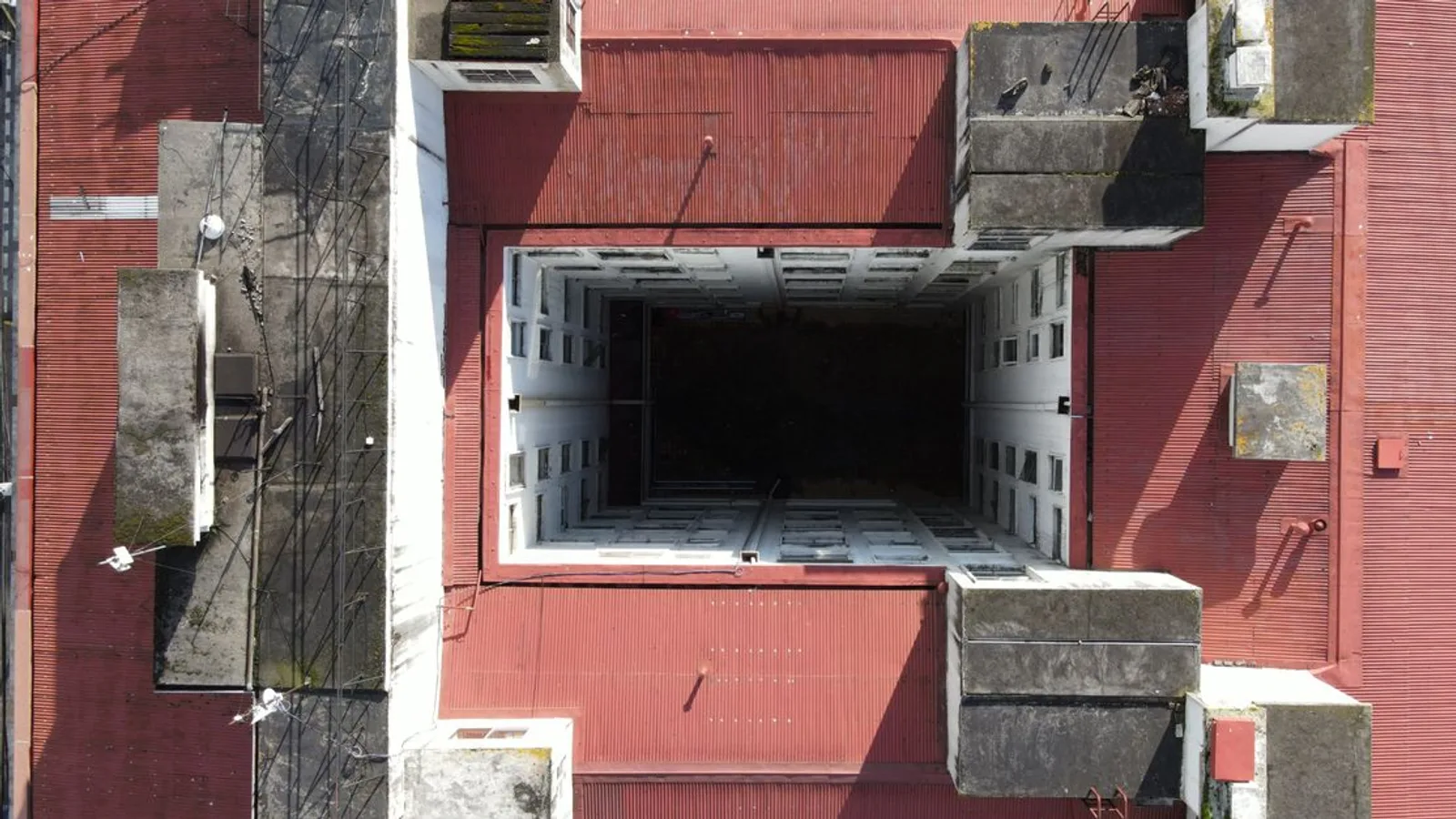 Bird's-eye view of a red-roofed building showcasing modern urban architecture, captured outdoors.