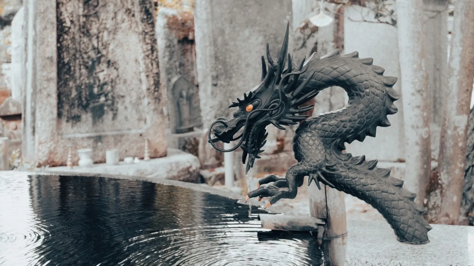 Elegant dragon statue at a traditional Japanese water fountain in Miyazu, Kyoto.